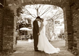 Monochrome image of couple standing in archway wedding photography in York
